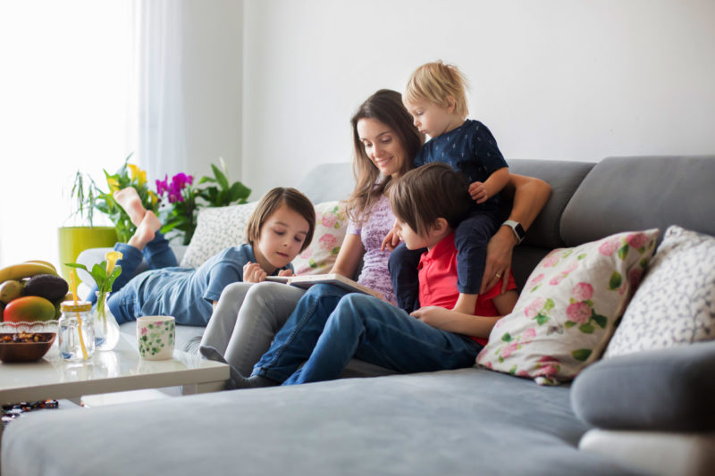 mom reading book to kids in house in summer, no AC problems